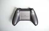 <p>The controller still takes AA batteries, but the humplike compartment is gone. So are the screwholes.